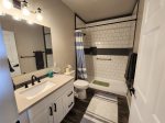 Main bath with walk in shower and handicap grab bars 